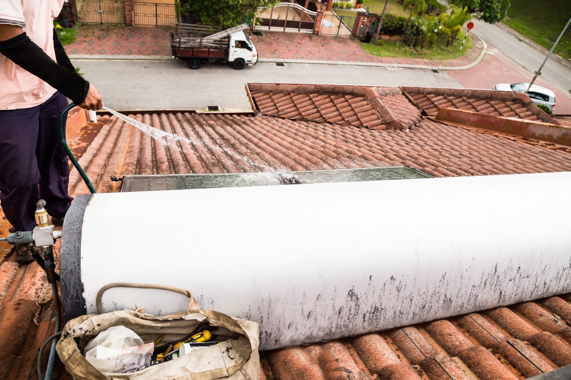 Worker Cleaning Solar Water Heater On Roof During 2021 08 30 18 49 37 Utc